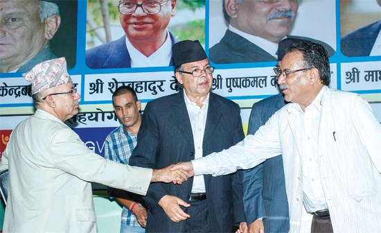 Prachanda (right) shakes hands with Madhav Kumar Nepal